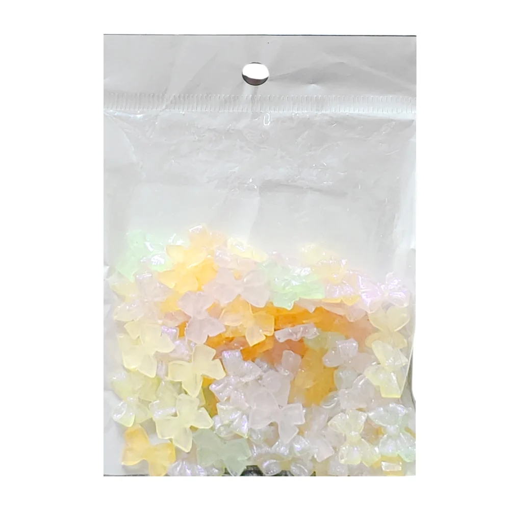 Paquete con 100 mini accesorios decorativos para uñas en forma de moñ…