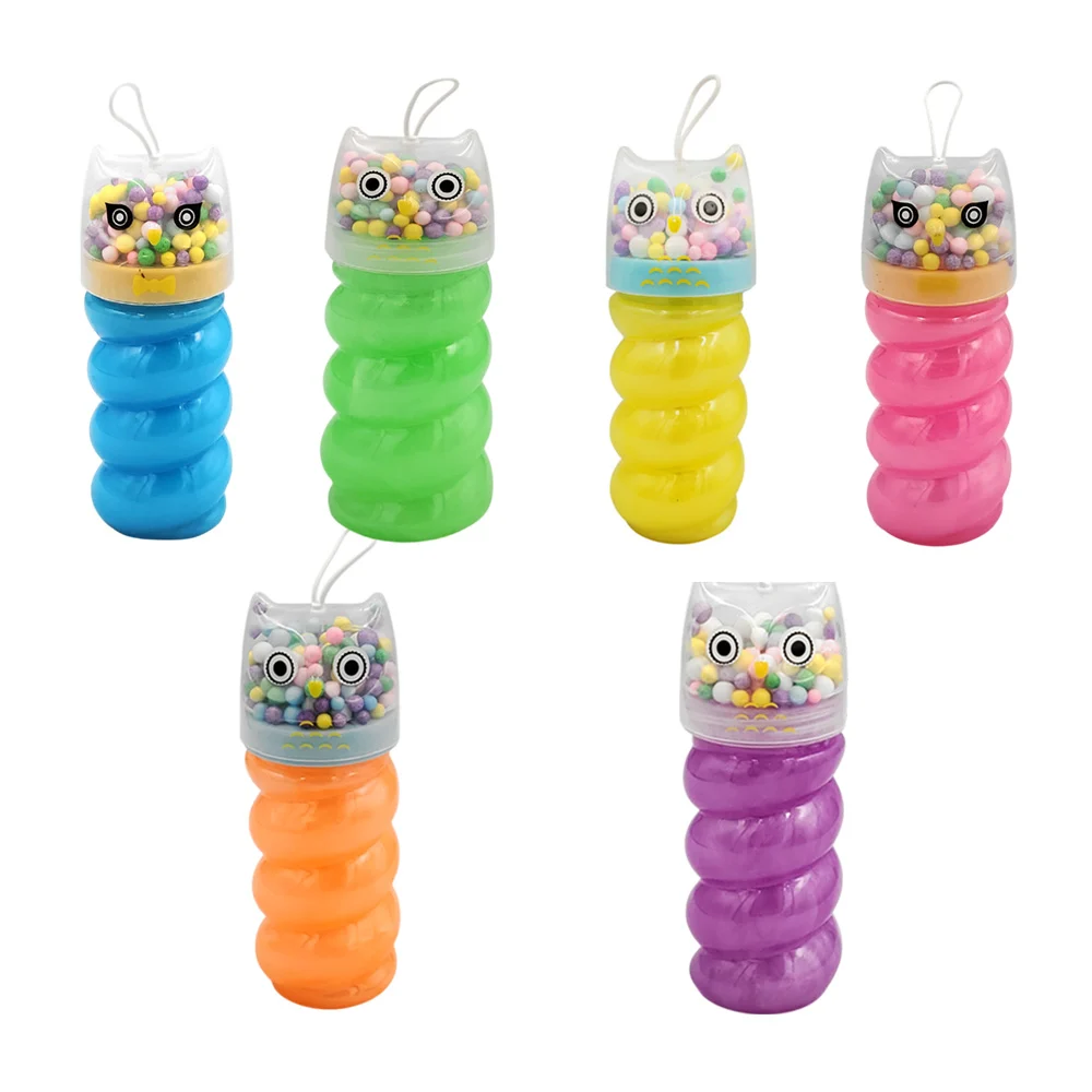 Bote espiral con slime brilloso y tapa de búho con bolitas de colores…