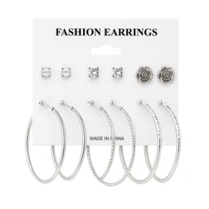 Blíster con 6 pares de aretes de fantasía en color plata, variedad de…