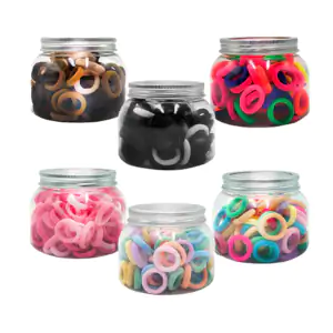 Bote con 100 pequeñas ligas aprox para cabello, variedad de colores