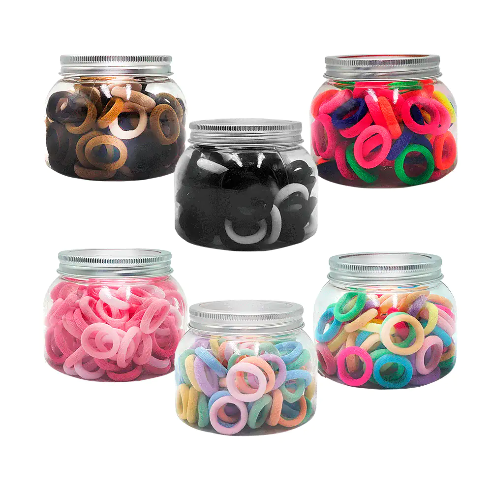 Bote con 100 pequeñas ligas aprox para cabello, variedad de colores