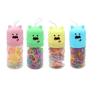 Bote transparente con ligas multicolores y tapa en forma de monstruo …